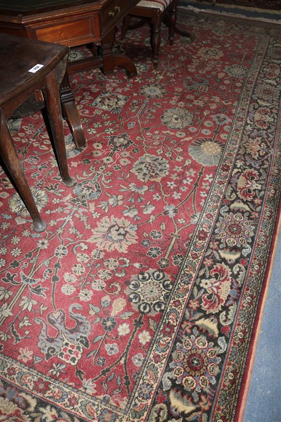 A large Persian style burgundy ground carpet, 360 x 276cms
